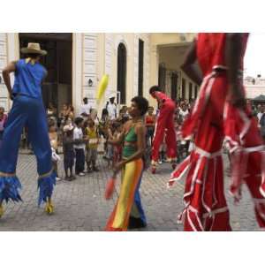  Group of People on Stilts and in Colourful Costumes Dancing 