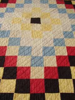 The quilt backing is made up of 3 widths of red and white homespun 