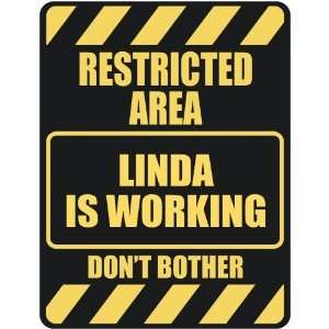   RESTRICTED AREA LINDA IS WORKING  PARKING SIGN