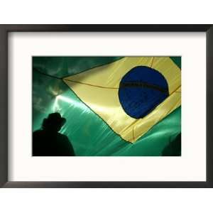  A Vendor Walks Behind a Big Brazilian Flag Framed 