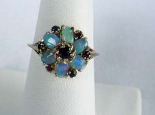  opal flower ring with very fiery opals It is accented by deep red 