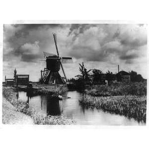  Windmill,Holland,Netherlands,man in rowboat,clouds