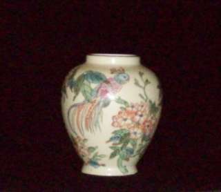   vase made in Macau. Beautiful flowers with a bird perched on a limb