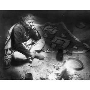 com c1915 photo Navajo Indian, seated by campfire, smoking cigarette 