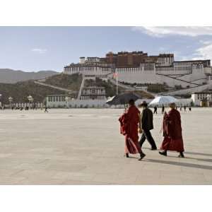 Monks Carrying Umbrellas to Shield Against the Sun, in Front of the 